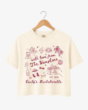 Bachelorette weekend crop top with playful illustrated doodles and script lettering. Personalized with bride name, year, and destination for the whole crew. Perfect for a Hamptons girls trip.