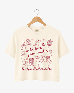Bachelorette party crop top with minimalist line-art doodle script for an Austin weekend. Personalized with bride name, year, and city for the whole crew.