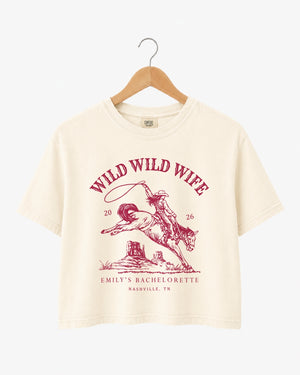 Bachelorette weekend crop top with vintage western rodeo art and Wild Wild Wife theme. Bride name, year, and destination city customizable for the whole Nashville-bound crew.