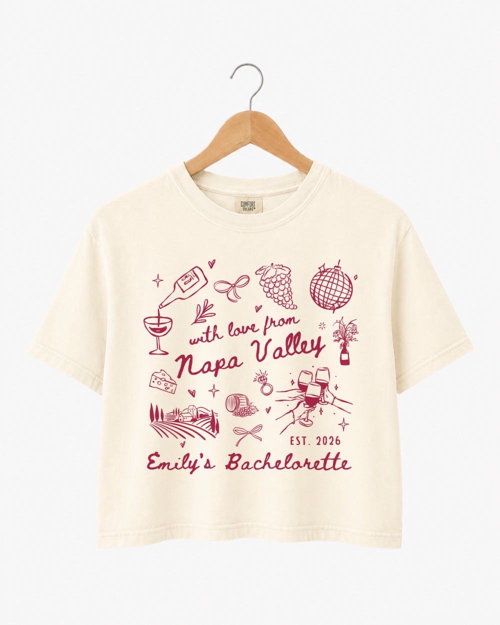 Napa Valley bachelorette weekend crop top with whimsical wine-country doodles and script typography. Bride name, year, and destination customizable for the full bridal crew.