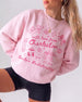 Bachelorette weekend sweatshirt with Charleston theme, playful doodle art, and script lettering. Personalized with bride name, destination city, and EST year for the whole crew.