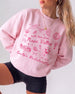 Bachelorette weekend sweatshirt with Napa Valley wine country theme, whimsical line-art doodles, and script lettering. Personalized with bride name, destination, and year for the whole crew.
