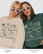Gift idea for the Las Vegas bachelorette crew: playful doodle-art sweatshirt personalized with bride name, destination city, and EST year. Perfect for the whole party.