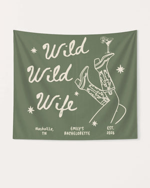 Gift idea for the bachelorette crew: Wild Wild Wife party banner with playful cowgirl and martini line art. Personalized with bride name, destination city, and wedding year.