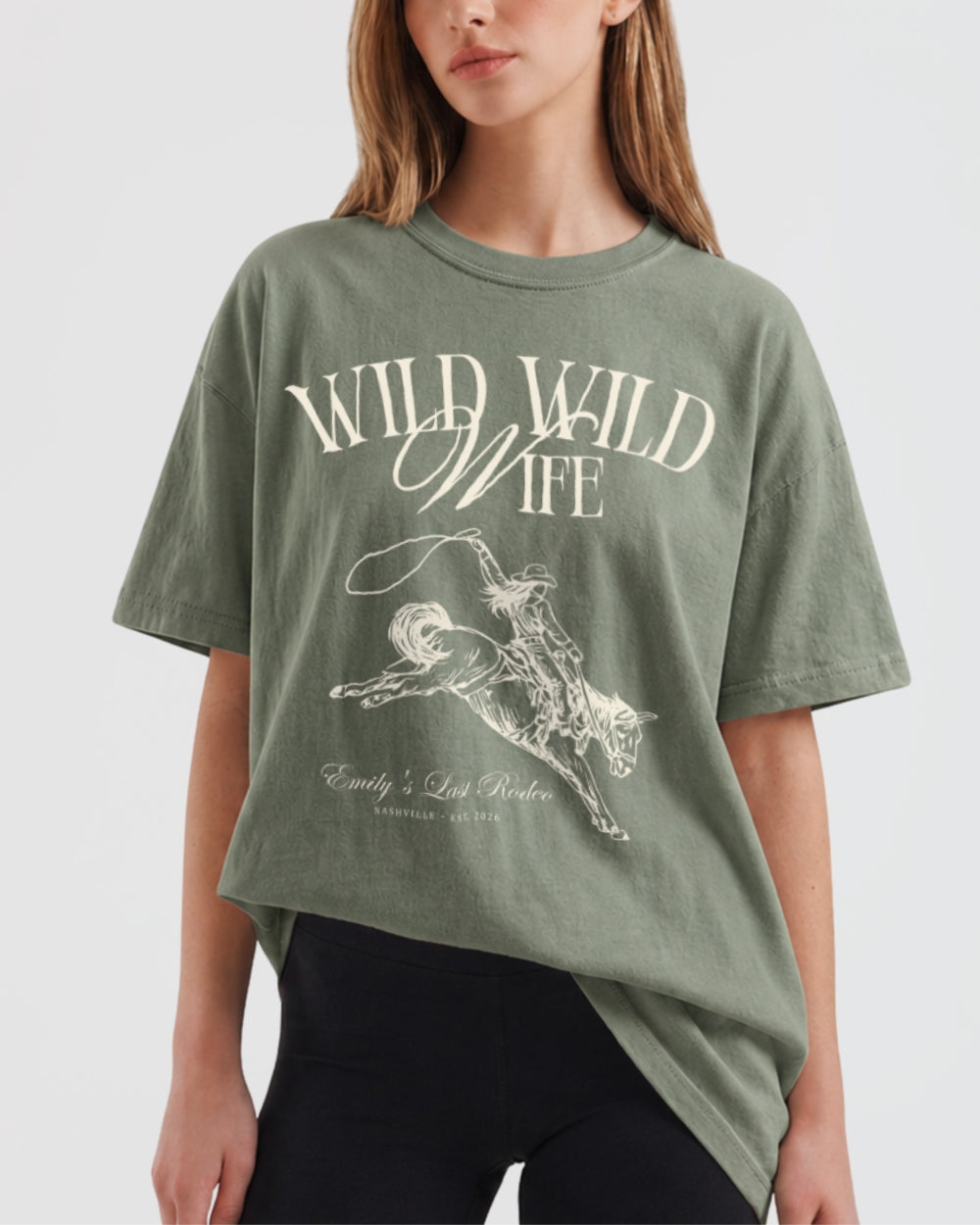 Vintage western-cut bachelorette tee with rodeo bride illustration and Wild Wild Wife script lettering, made for the bride and her crew at a western or cowgirl-themed bachelorette party.