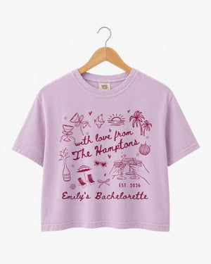 Bride and bridesmaids matching crop tops for a Hamptons bachelorette weekend. Playful illustrated doodle art with script lettering, personalized with bride name, date, and destination.