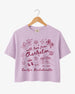Bride and bridesmaids matching crop tops for a Charleston bachelorette weekend. Hand-drawn doodle script with playful icons, personalized with bride name, destination city, and EST year.