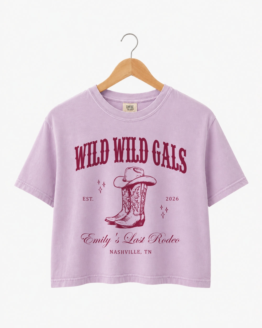 Bride and bridesmaids matching crop tops for a Wild Wild Wife cowgirl bachelorette party. Vintage western doodle art with script typography, personalized with name, year, and destination city.