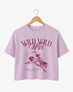 Bride and bridesmaids matching crop tops for a Wild Wild Wife western bachelorette weekend. Vintage rodeo art with personalized name, date, and city for the full crew.