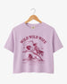 Bride and bridesmaid crop tops for a Wild Wild Wife bachelorette weekend with vintage western rodeo art. Personalize with bride name, year, and destination city for the full crew.
