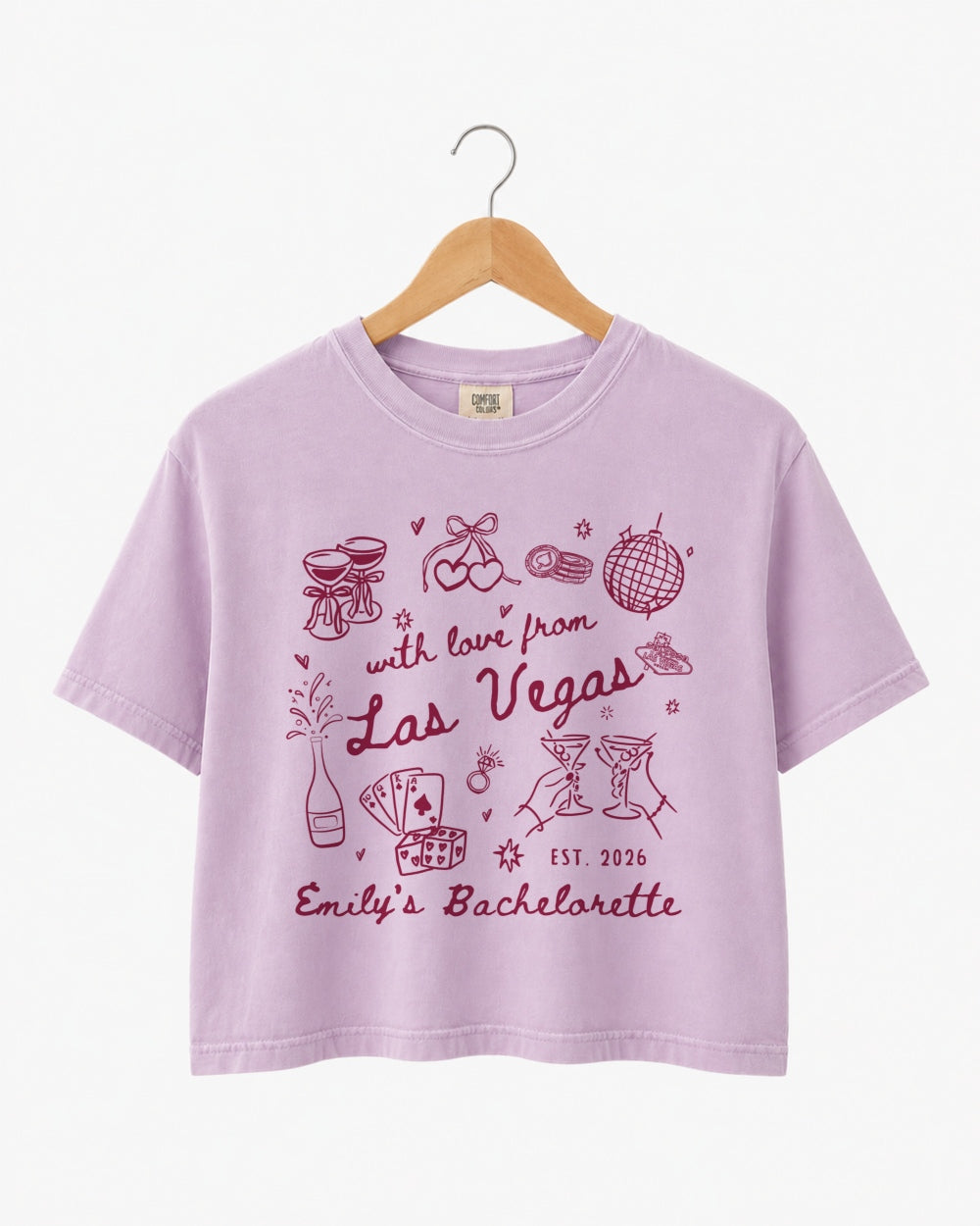 Bride and bridesmaids matching Las Vegas bachelorette crop tops with vintage line-art illustration and script lettering. Personalized with bride name, year, and destination city for the whole crew.