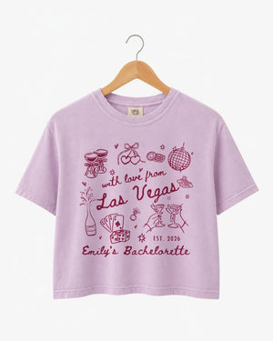 Bride and bridesmaids matching Las Vegas bachelorette crop tops with vintage line-art illustration and script lettering. Personalized with bride name, year, and destination city for the whole crew.