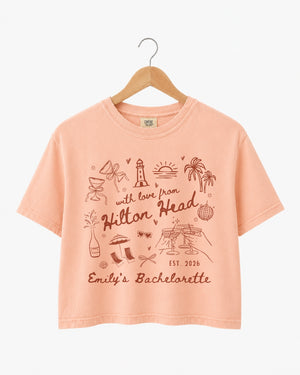 Playful line-art doodle bachelorette crop top with hand-drawn script and whimsical illustrations. Personalized with bride name, destination, and EST year for the whole bachelorette crew.