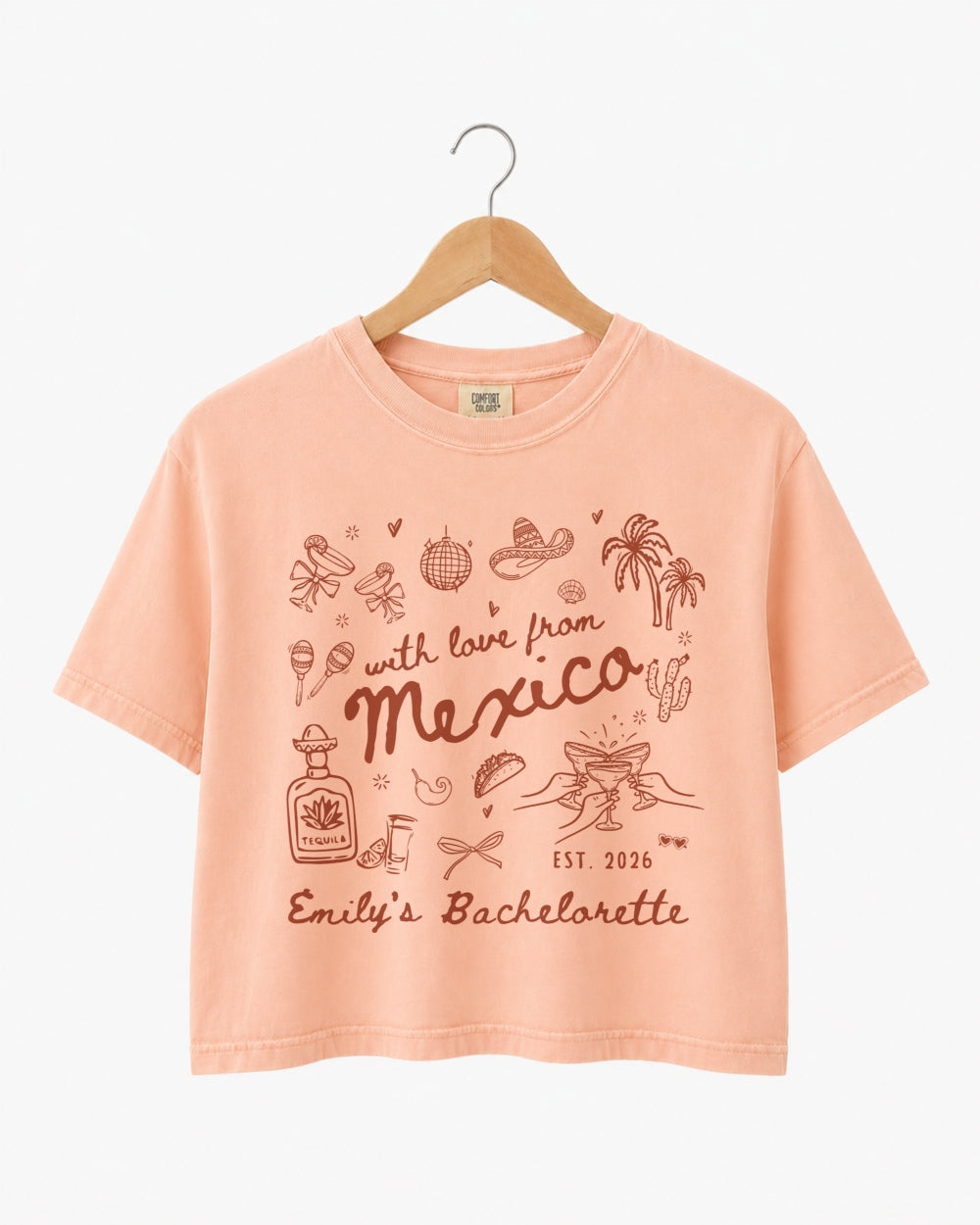 Playful hand-drawn line art bachelorette crop top with script lettering and a Mexico destination theme. Personalized with bride name, year, and destination for the whole crew.