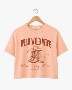 Cropped bachelorette top with vintage western illustration and script typography for a cowgirl bride bachelorette. Personalized with bride name, year, and destination city for the full Nashville crew.
