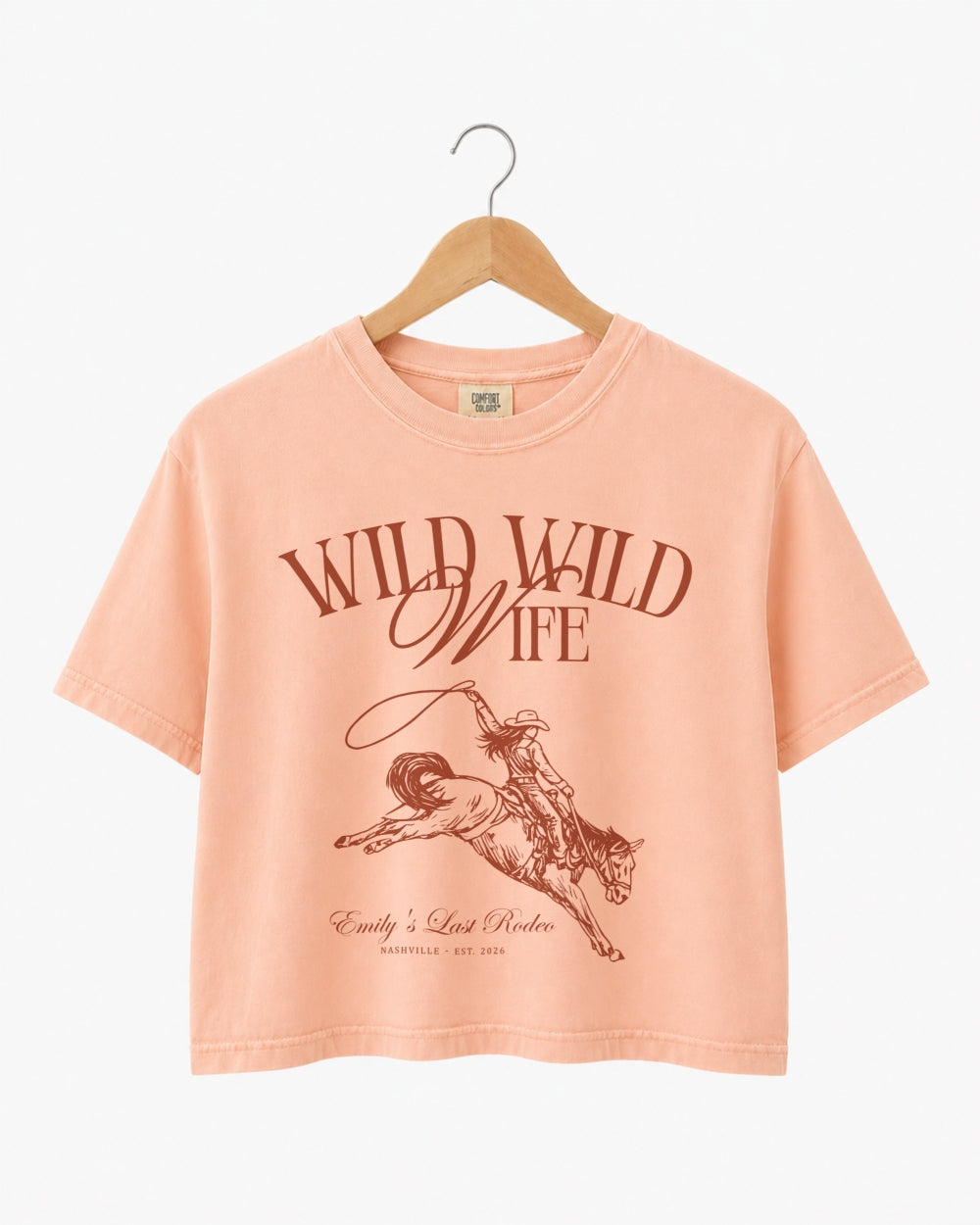 Vintage western illustration bachelorette crop top with script typography and rodeo art. Personalized with bride name, destination city, and year for the whole bachelorette crew.