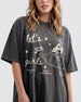 Girls night out tee with vintage cowgirl bottle illustration and Let's Go Girls script. Casual statement shirt for bar crawls, country concerts, and bachelorette weekends.