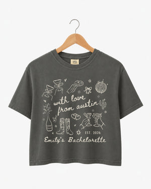 Cropped bachelorette party top with minimalist line-art doodle script, destination city and bride name customizable. Perfect for the Austin bachelorette crew or any girls trip weekend.