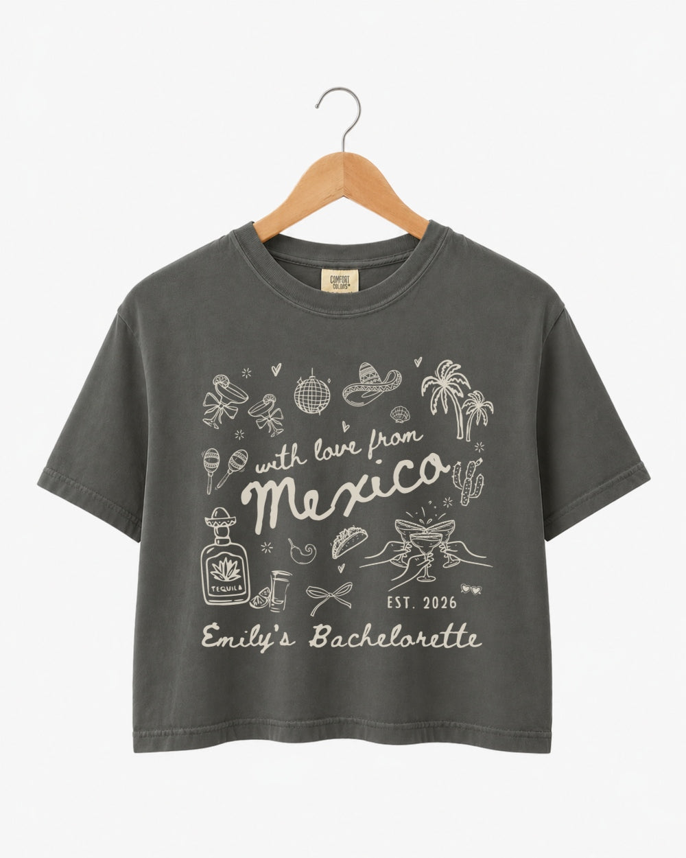 Cropped bachelorette top with playful hand-drawn script art for a Mexico destination weekend. Personalized with bride name, bachelorette title, and year for the full crew.