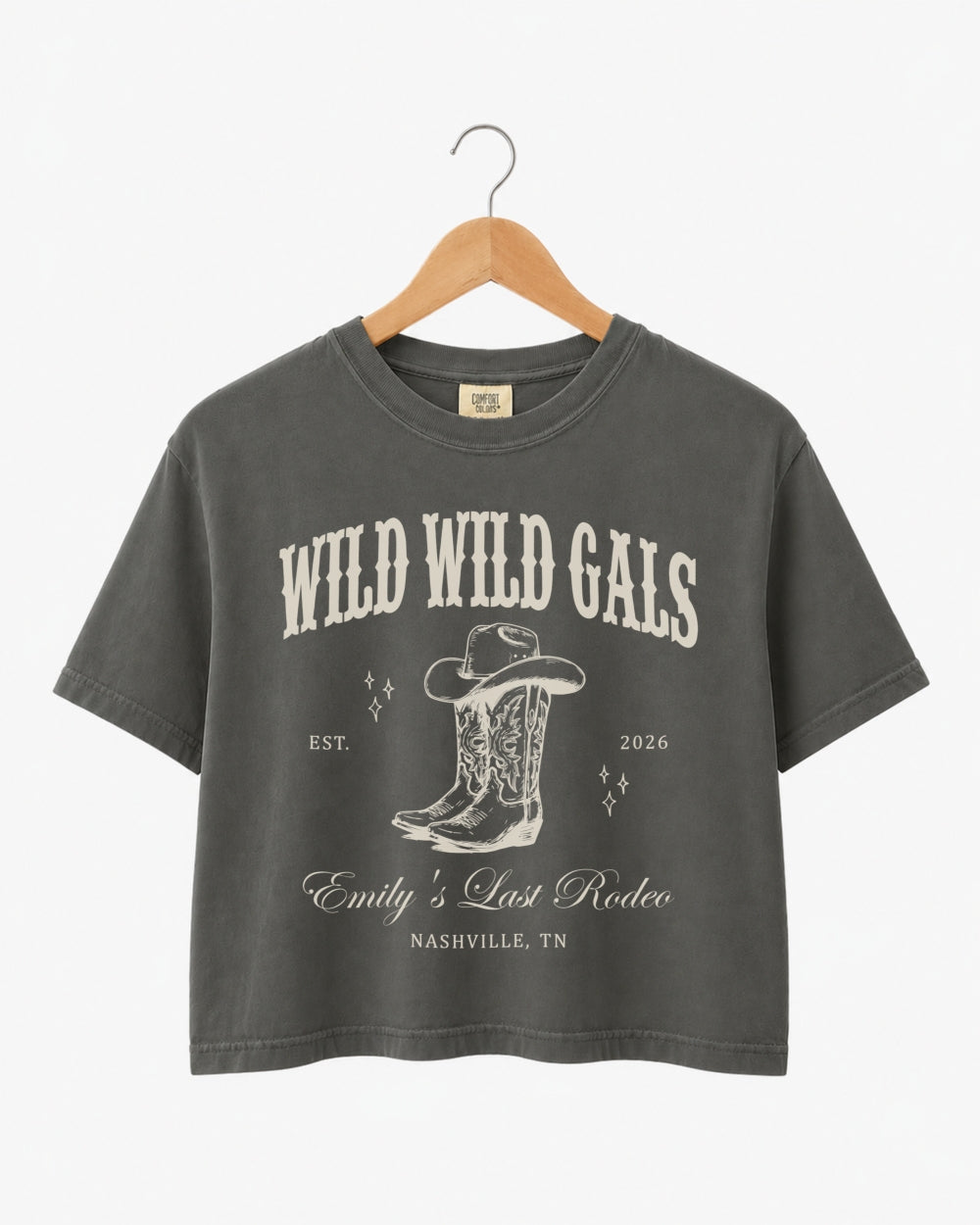 Vintage western script bachelorette crop top with cowgirl bride illustration, Wild Wild Wife theme. Personalized with bride name, est. year, and destination city for the full crew.