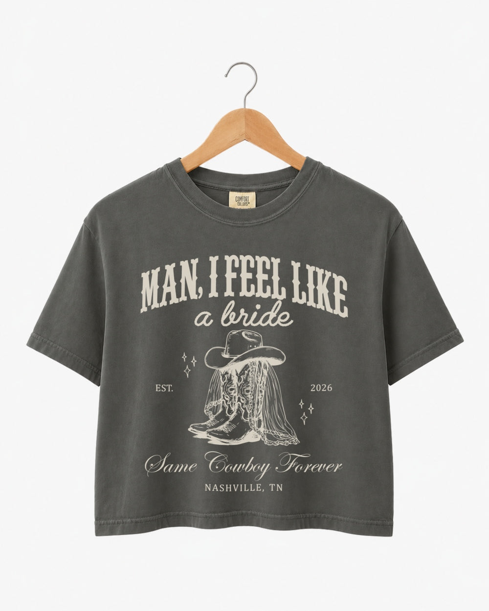 Cropped bachelorette tee with vintage western script and cowboy boot illustration for a Nashville rodeo weekend. Personalized with bride name, year, and city for the full Last Rodeo crew.