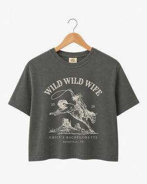 Cropped bachelorette tee with vintage western rodeo art for the Wild Wild Wife crew. Personalize with bride name, date, and destination city for every member of the bridal party.
