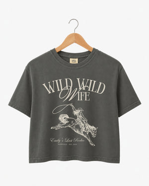 Cropped bachelorette tee with vintage western illustration for the Wild Wild Wife crew. Personalized with bride name, destination city, and year for the whole rodeo party.