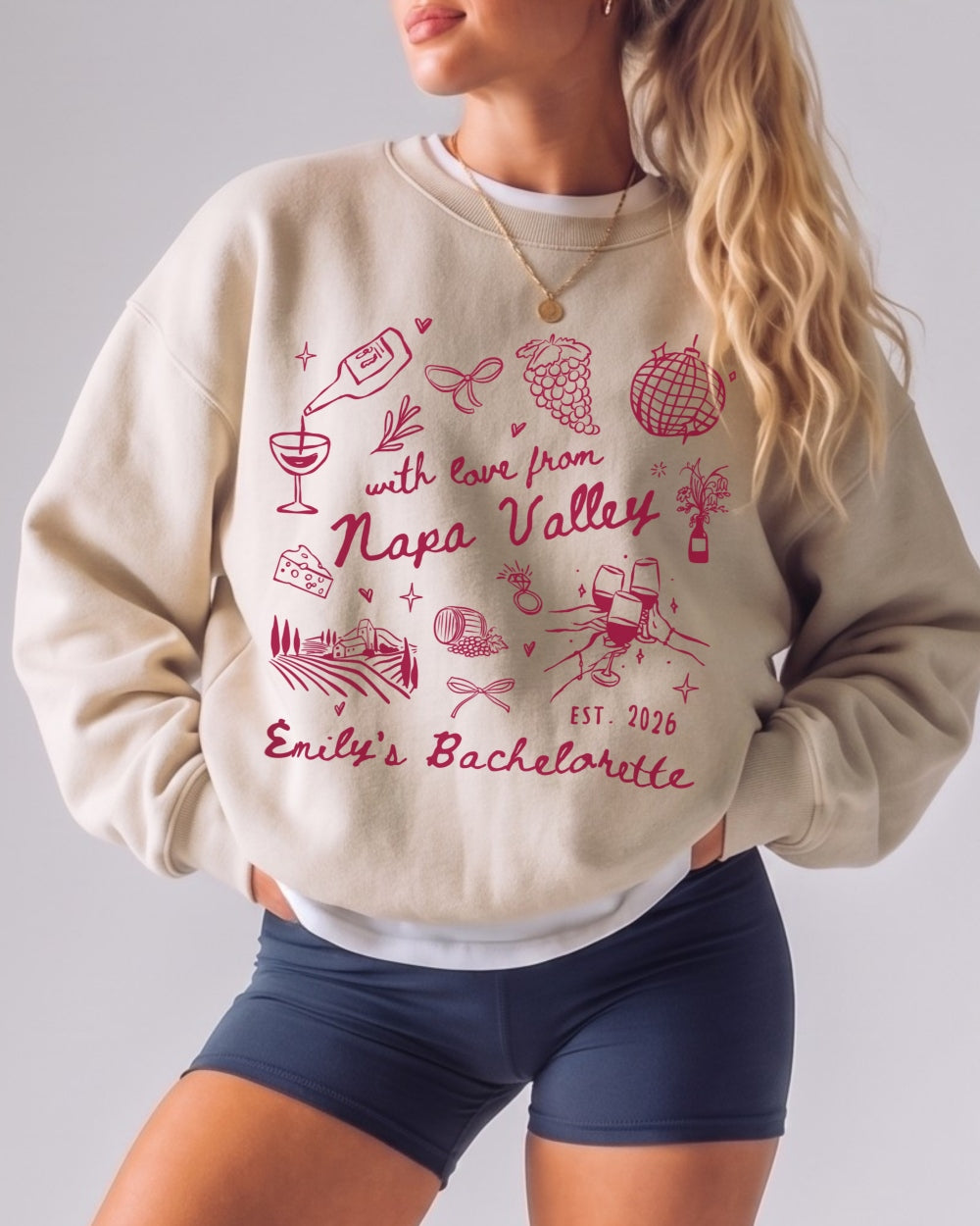Bachelorette weekend sweatshirt with Napa Valley wine country theme, whimsical doodle art, and script lettering. Personalized with bride name, date, and destination for the whole bridal crew.