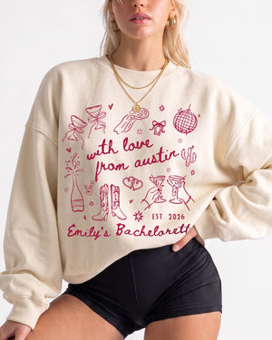 Bride and bridesmaids matching bachelorette sweatshirts with soft doodle art and Austin-inspired script. Personalized with bride name, destination city, and year for the whole crew.
