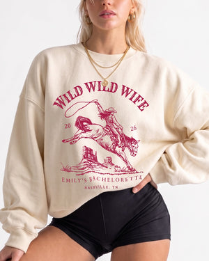 Personalized Wild Wild Wife bachelorette sweatshirt with vintage western rodeo art. Add the bride's name, year, and destination city for the whole crew's Nashville or any-city weekend.
