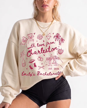 Gift idea for the bride squad: bachelorette sweatshirt with playful line-art doodles and script lettering. Personalized with bride name, destination city, and EST year for the whole crew.
