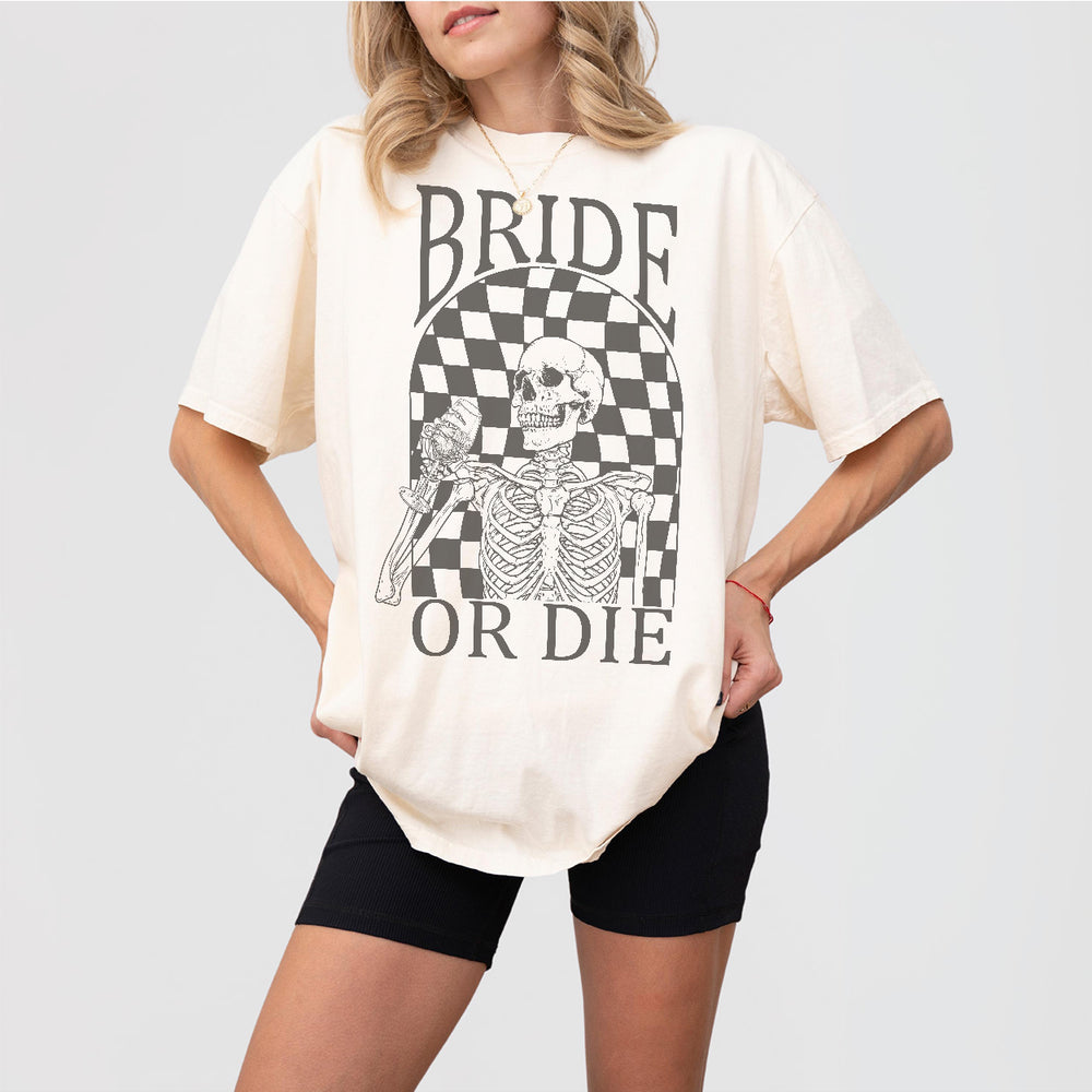 Ivory cotton funny bachelorette party shirt for the bride featuring a witchy "Til Death Do Us Party" design, perfect for Halloween weddings or spooky bridal showers