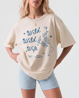Personalized bachelorette t-shirt with Wild Wild Wife vintage script design, customizable with bride name, date, and destination city for the whole bachelorette weekend crew.