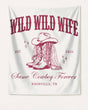 Gift idea for a cowgirl bachelorette party: Wild Wild Wife banner with vintage western illustration and script lettering. Customizable with bride name, year, and destination city.