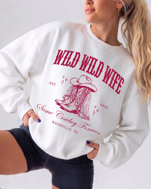 Vintage western varsity sweatshirt for bachelorette parties with bold boot graphic and retro script lettering. Country bride crew style, customizable with name, year, and destination city.