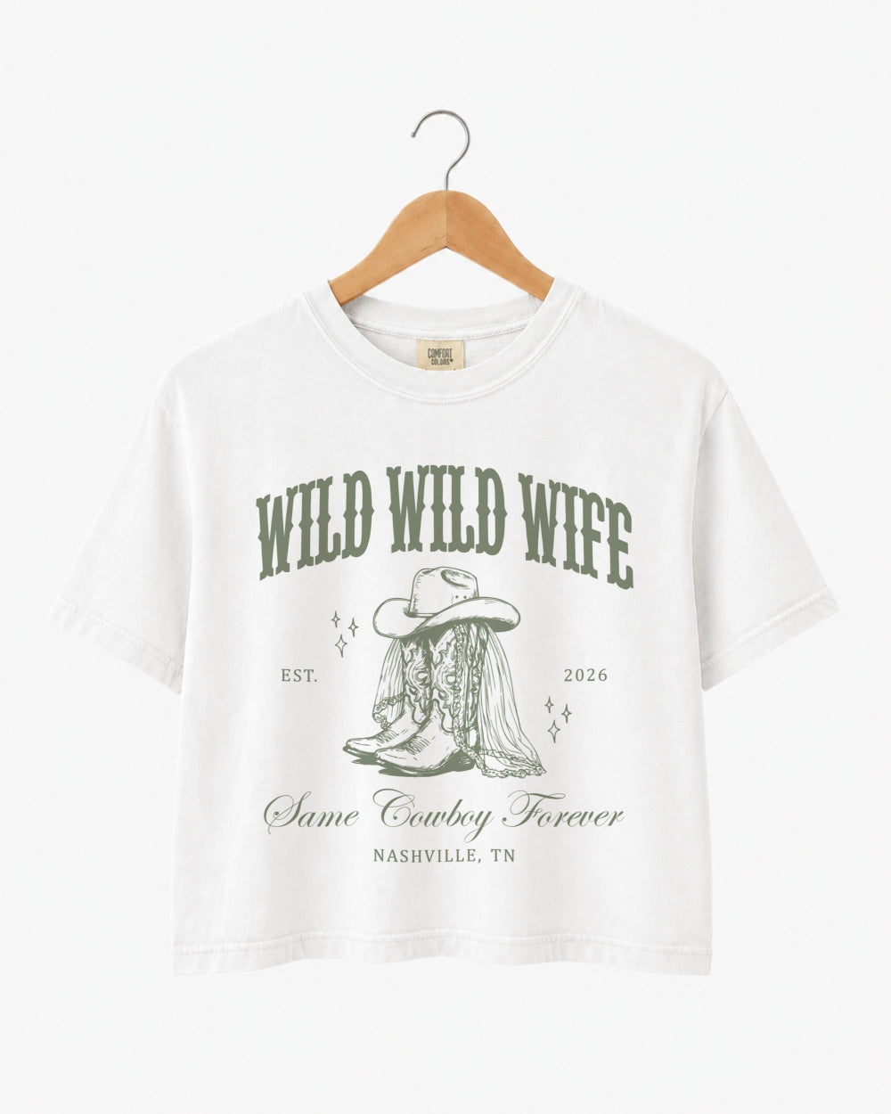 Bachelorette weekend crop top with vintage western illustration and cowgirl bride theme. Wild Wild Wife design with script typography, personalized with bride name, year, and destination city.