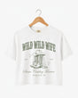 Bachelorette weekend crop top with vintage western illustration and cowgirl bride theme. Wild Wild Wife design with script typography, personalized with bride name, year, and destination city.