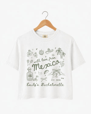 Mexico bachelorette weekend crop top with playful hand-drawn script art for the bride and her crew. Personalized with bride name, destination, and EST year for the full trip.