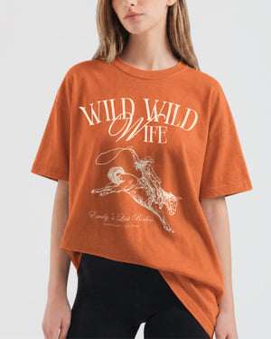 Gift idea for the western bride: Wild Wild Wife bachelorette T-shirt with vintage rodeo illustration and script lettering. Perfect for the bride squad heading to a country concert or ranch weekend.