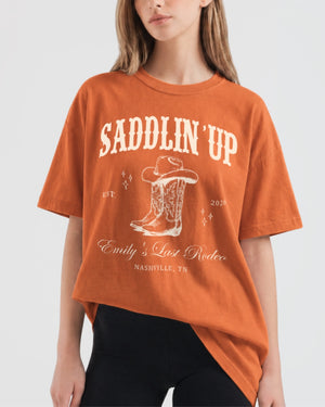 Gift idea for the bride heading into her last rodeo: western bachelorette T-shirt with vintage cowboy boot art. Personalized with bride name, wedding year, and destination city for the whole crew.