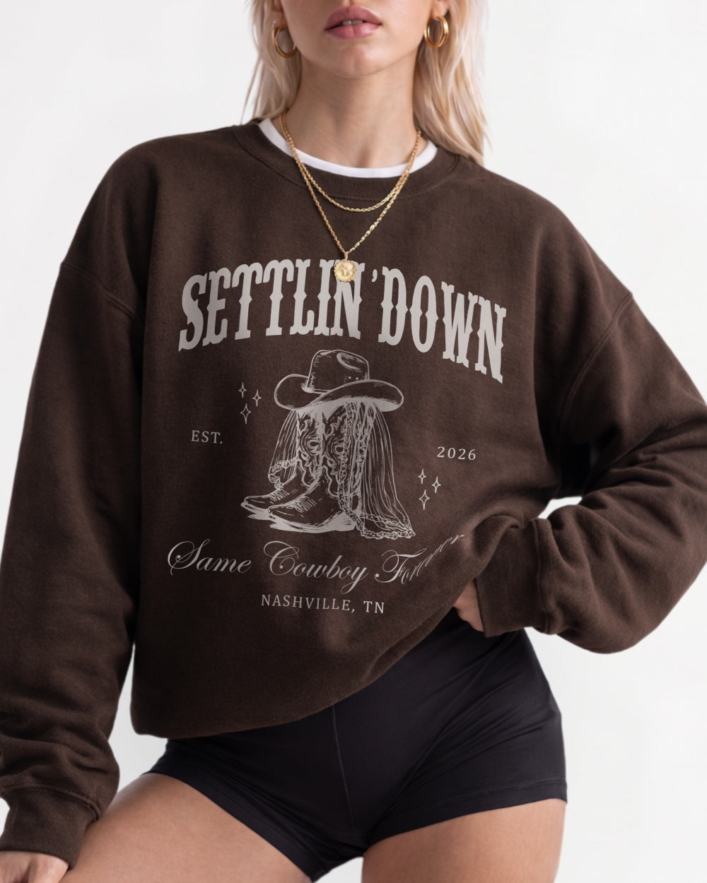 Vintage western illustration bachelorette sweatshirt with serif typography and a saddle-up theme. Personalized with bride name, party date, and destination city for the whole crew.