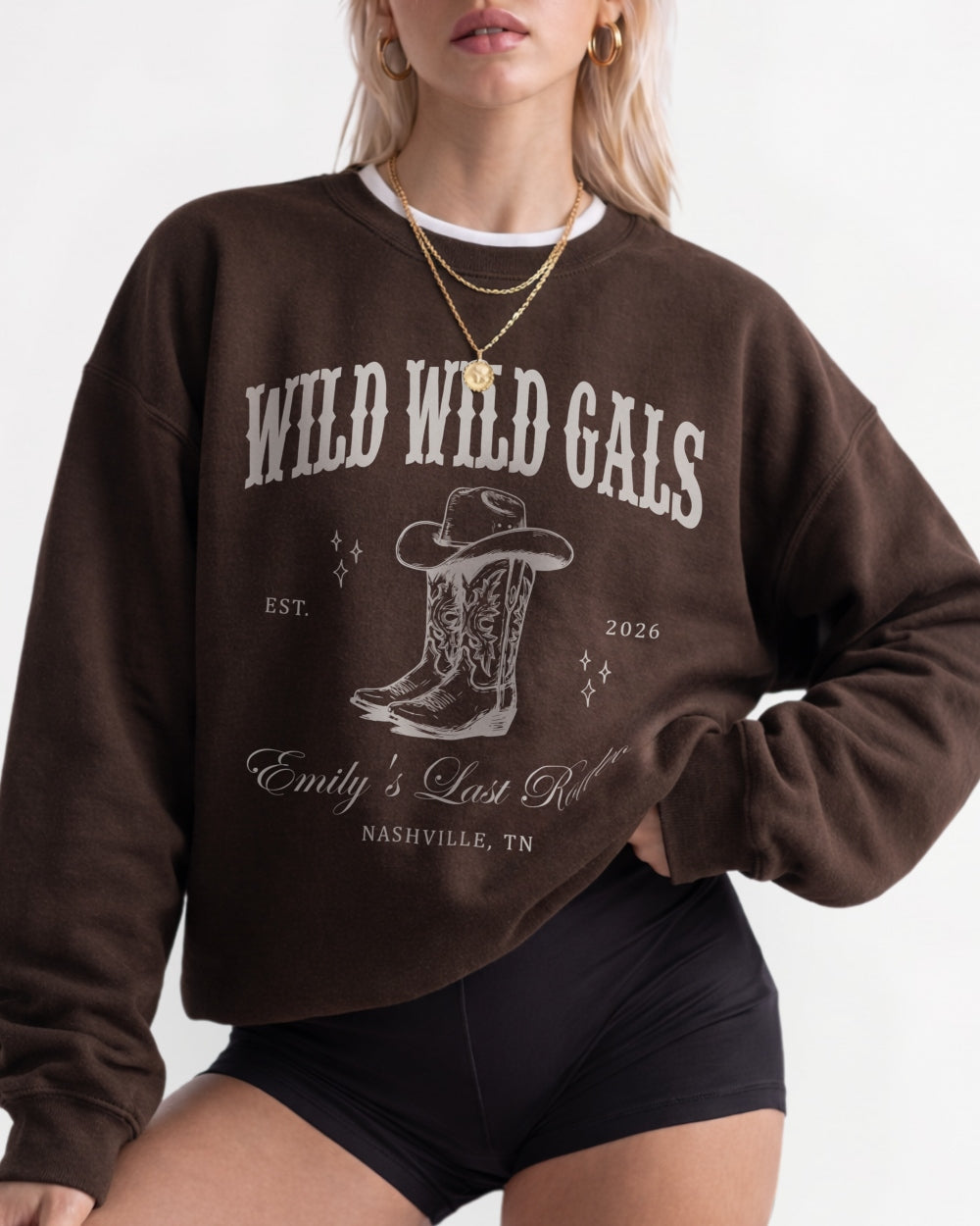 Pullover sweatshirt for the Wild Wild Wife bachelorette crew, country western theme with vintage cowboy boots graphic and varsity-style lettering. Bride name, year, and destination customizable.