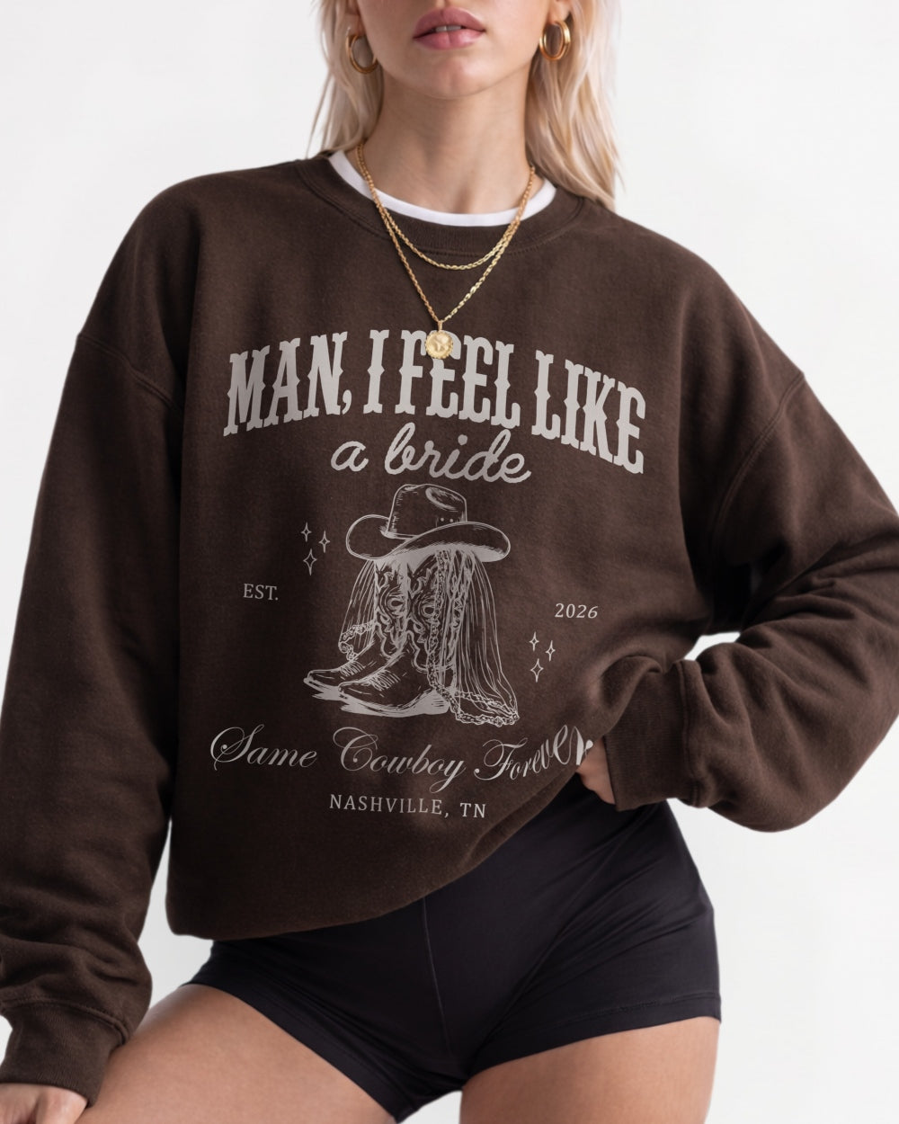 Bold pink serif typography and vintage cowboy boot illustration on a bachelorette sweatshirt. Country western Last Rodeo theme with bride name, year, and city personalized for the whole crew.