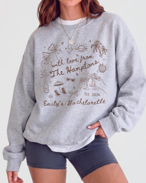 Gift idea for the bride-to-be: Hamptons bachelorette sweatshirt with playful hand-drawn script art. Personalized with bride name, year, and destination for the whole crew.
