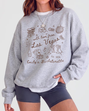 Gift idea for the Las Vegas bachelorette crew: matching sweatshirts with playful doodle art and script. Personalized with bride name, destination, and year for the whole party.